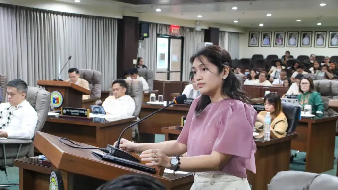 Cagayan de Oro City Councilor Yevonna Yacine Emano speaking at the podium inside the city council session hall during debates over the proposed ₱8.5-billion Government Complex loan.