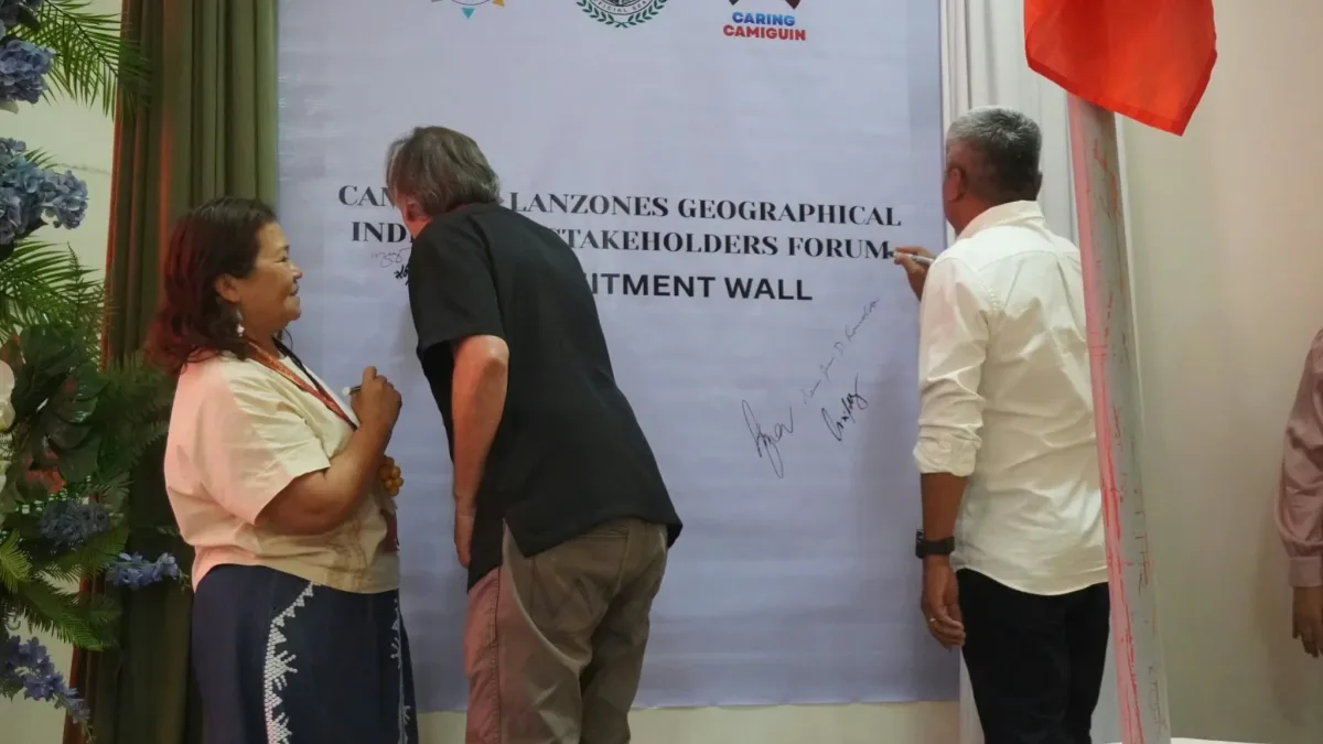 Stakeholders, led by Mambajao Sangguniang Bayan member Zita Abellare, REDD lead consultant Peter Damary, and local leaders, sign a commitment wall during the Camiguin Lanzones Geographical Indication Stakeholders Forum at the New Provincial Capitol in Mambajao.