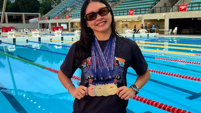 Seventeen-year-old swimmer Claeson Therese R. Alvarez of Claret School of Zamboanga City displays six national medals won at the New Clark City Aquatics Center in Capas, Tarlac.