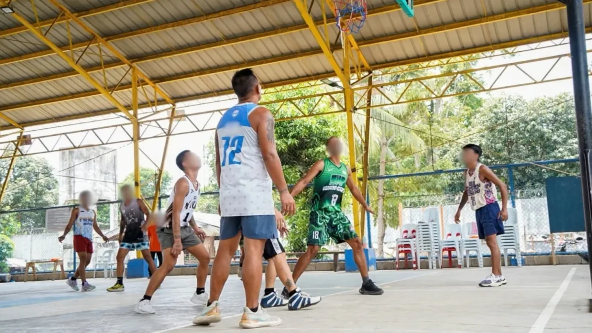 Persons Deprived of Liberty (PDLs) participate in a basketball tournament on a covered court at the Davao Oriental Provincial Rehabilitation and Reformatory Center.
