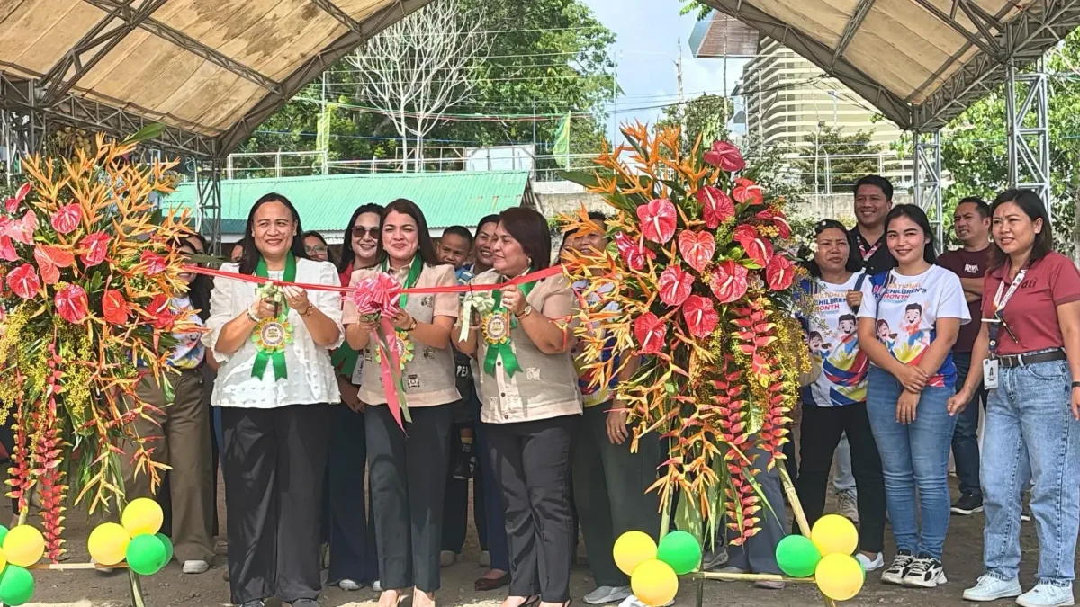 Officials from the Department of Trade and Industry (DTI) Camiguin and local leaders perform a ceremonial ribbon-cutting to open the Diskwento Caravan Lanzones Festival Edition at the UGMAD Activity Center in Mambajao.