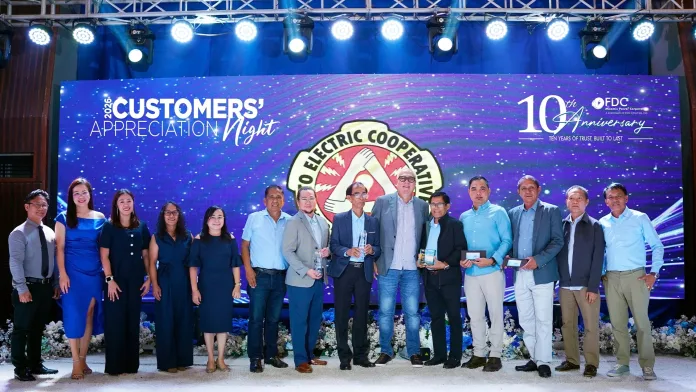 Delegates from the Cotabato Electric Cooperative, Inc. (COTELCO) receive an award on stage from FDC Misamis Power Corporation President and CEO Juan Eugenio Roxas during the company's 10th Anniversary Customers' Appreciation Night.