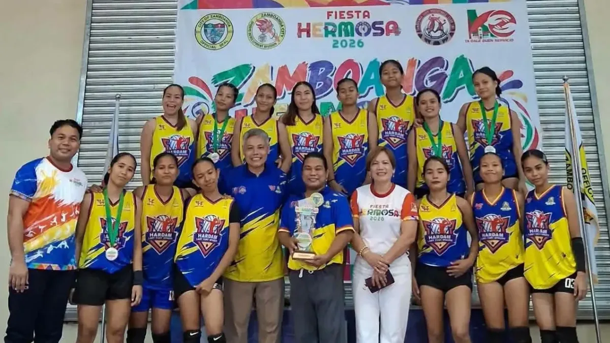 Members of the Hardam Furigay Colleges Foundation, Inc. (HFCFI) Lady Fury Spikers pose on stage with their championship trophy and medals after winning the women's division at the Zamboanga Hermosa Volleyball Tournament 2026.
