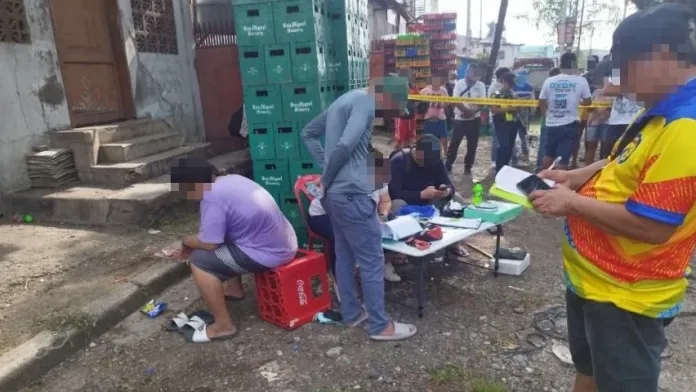 PDEA operatives, police officers, and mandated witnesses conduct an on-site inventory of 540.8 grams of seized suspected shabu on a folding table at Purok 6, Palm Court in Barangay Tomas Cabili, Iligan City.