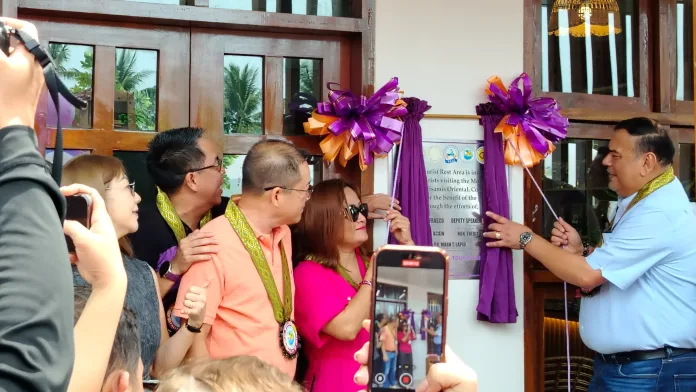 DOT-10 Regional Director Ellaine Unchuan, Misamis Oriental 2nd District Rep. Yevgeny Vincente Emano, and local officials unveil the commemorative plaque during the inauguration of the country's first solar-powered Tourist Rest Area in Barangay Jampason, Initao, Misamis Oriental.