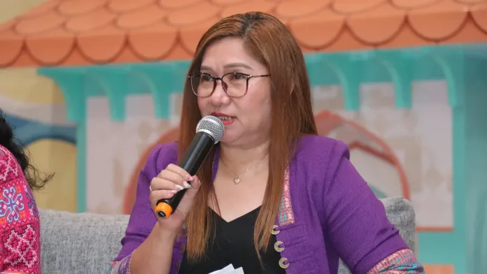Philippine Statistics Authority-10 Regional Director Janith Aves wears eyeglasses and a purple patterned jacket while speaking into a microphone during the Kapihan sa PIA media forum in Cagayan de Oro City.