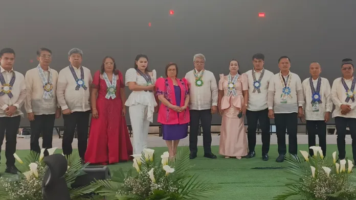 Mayor Sonia A. Arnado, Vice Mayor Rommel C. Arnado, and municipal council members pose on stage in formal Filipiniana and Barong Tagalog during the joint State of the Municipality Address and State of the Legislature Address at the Kauswagan International Organic Convention Center.