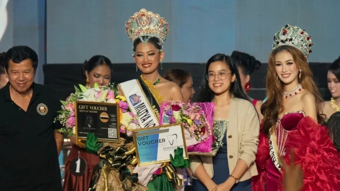 Keren Isabel Cleland smiles proudly while wearing her crown and sash as Mutya ng Tubod 2026, posing with sponsors and delegates holding award vouchers and floral bouquets on stage at the Tubod Cultural Center.