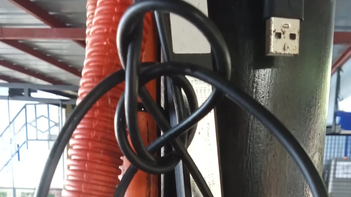 Exposed electrical cables, flexible conduit piping, and wiring tied around a metal post in Medina, Misamis Oriental.
