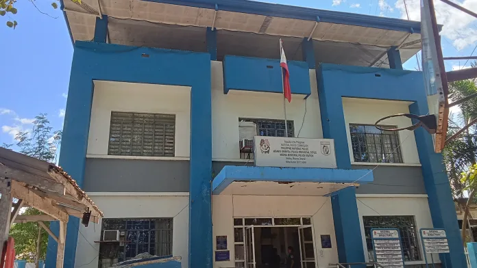 The facade of the blue and white Medina Municipal Police Station building in Medina, Misamis Oriental.