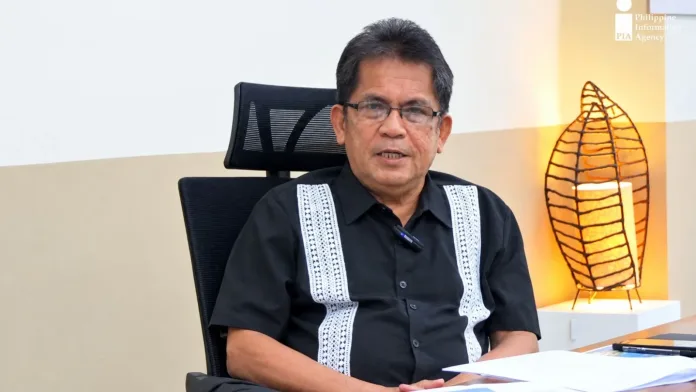 Oro Chamber President Almarco C. Brito sits at a desk during an interview discussing ASEAN trade opportunities and export readiness for Northern Mindanao MSMEs.