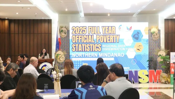 Philippine Statistics Authority Region 10 Director Janith C. Aves speaks at a podium during the 2025 Official Poverty Statistics Regional Data Dissemination Forum in Northern Mindanao before an audience of government officials and stakeholders.