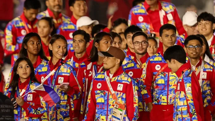 Members of Team Philippines march during the Asiad Games 2026 parade, wearing official national team jackets while carrying the Philippine flag.