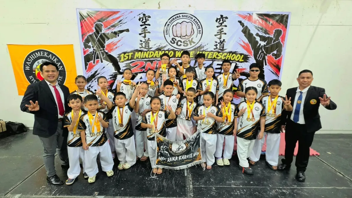 Young karatekas and instructors from Davao City-based Raika Karate Kan display their medals, banner, and overall championship trophy following the 2nd Shizen Karatedo Tournament Mindanao-Wide Interschool in Koronadal City.