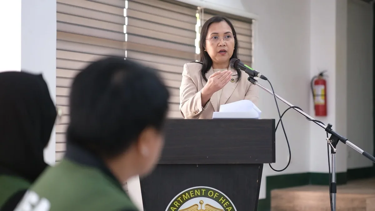 Regional Prosecutor Merlynn Barola-Uy speaks into a microphone at a podium during the Regional Inter-Agency Committee on Anti-Illegal Drugs Coordinating Group 10 meeting in Cagayan de Oro City.