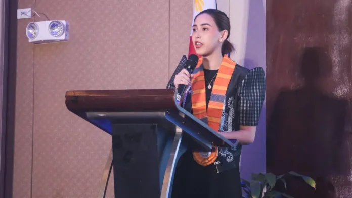Department of Energy Assistant Secretary Sabine Marie Romero speaks into a microphone at a podium during the 4th Mindanao Clean Energy Forum in General Santos City.