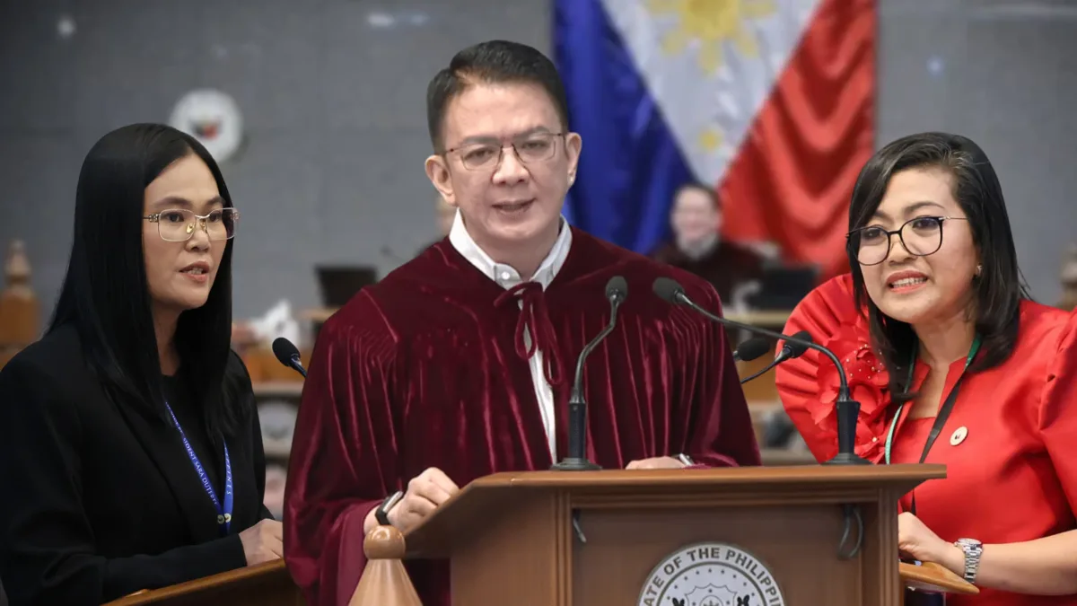 Presiding Officer Sen. Francis Escudero in a red robe stands at the podium flanked by defense counsel Atty. Sheila Sison and lead prosecutor Rep. Gerville Luistro inside the Senate impeachment court.