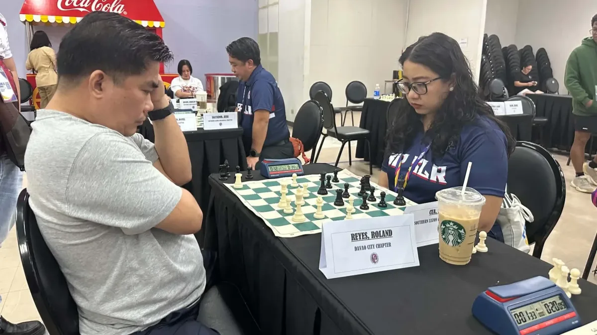 Woman FIDE Master Atty. Sherily Cua (right) of the Southern Luzon Chapter and Atty. Roland Reyes (left) of the Davao City Chapter ponder their moves over a chessboard at SM City Uptown in Cagayan de Oro City.