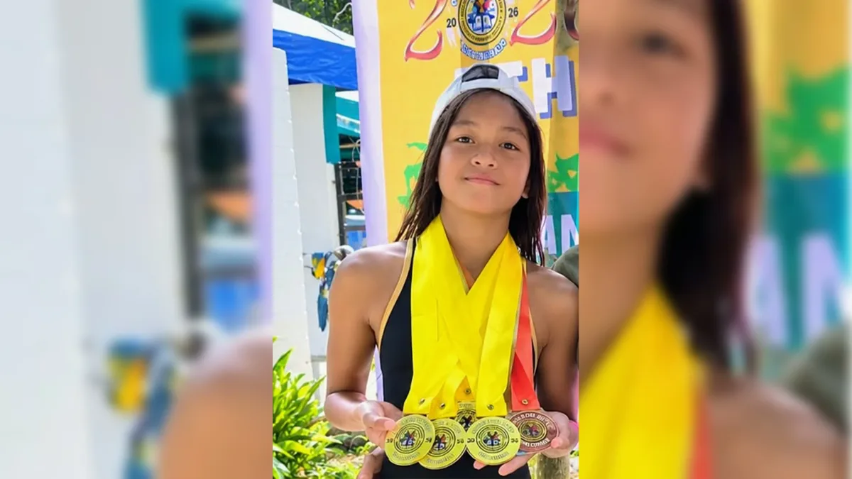 St. Mary’s School student-athlete Alexa Ann T. Epan holds up multiple gold, silver, and bronze swimming medals around her neck in Cagayan de Oro City.
