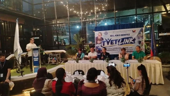 TESDA Director General Secretary Kiko Benitez speaks at a podium alongside Iligan City local officials and stakeholders during a TVET forum on workforce development.