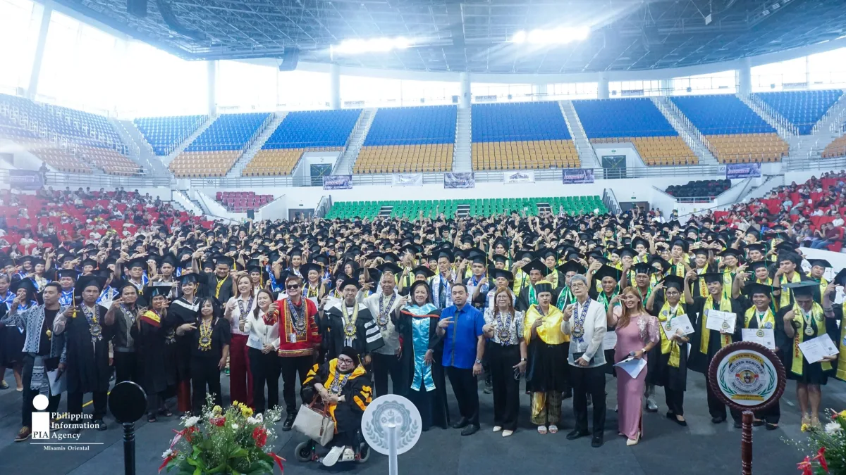 A large crowd of 1,083 technical-vocational graduates in academic caps and gowns poses with TESDA and school officials inside the Aquilino Q. Pimentel Jr. Convention Center in Cagayan de Oro City.