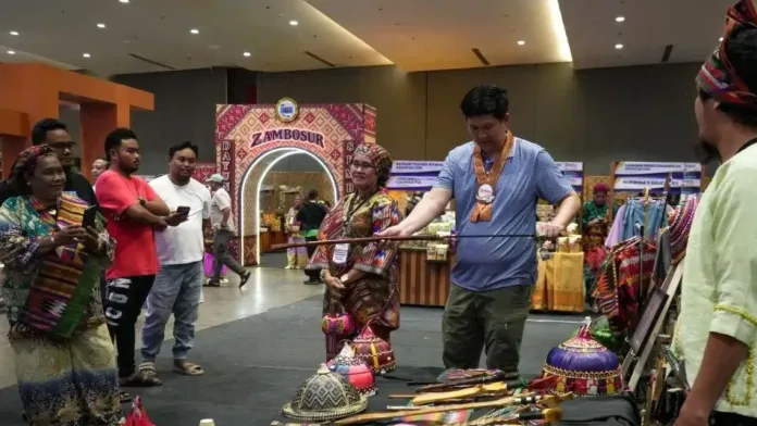 Zamboanga City Mayor Khymer Olaso examines a traditional sword at a handicraft booth during the 12th Zamboanga Peninsula Exposition (ZAMPEX) 2026 at the KCC Convention Center.